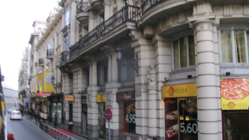 MADRID - MAR 10: (Timelapse View) Bus go near sidewalks on which people walk in afternoon, on Mar 10, 2012 in Madrid, Spain