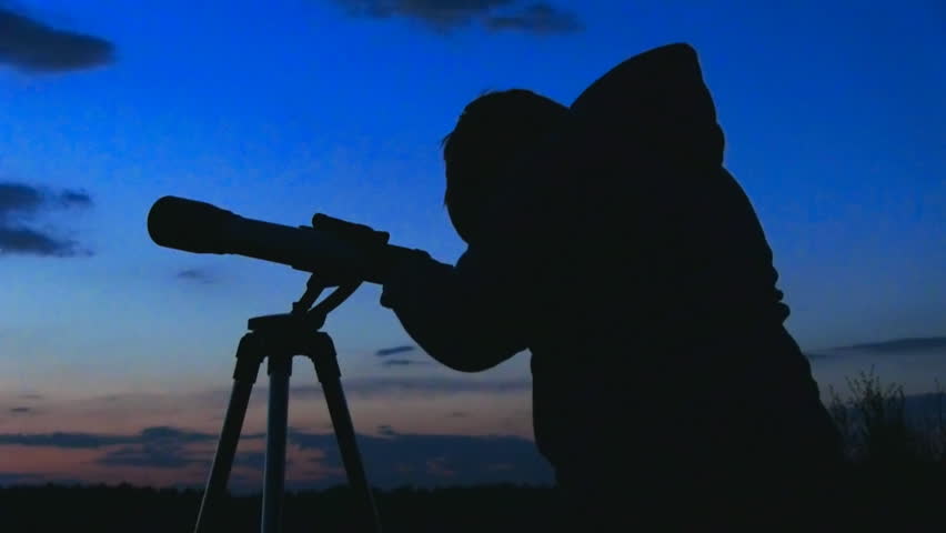 silhouette of telescope and astronomer