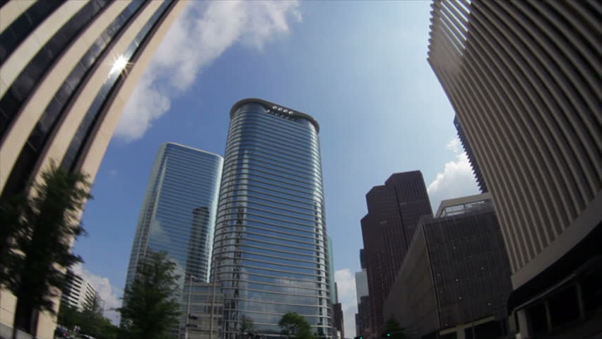 The fisheye lens distorts the skyscrapers of downtown Houston making them appear to twist and bend. Driving video.