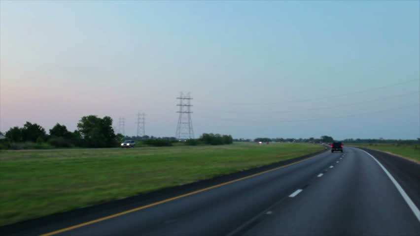 The highway passes under and expanse of overhead high voltage power ines.
