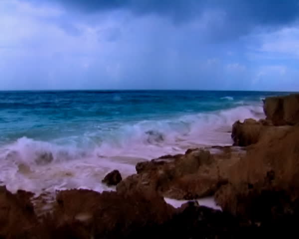 Waves hits reef in a dark day. Colors were altered to create contrast between rocks and ocean. * Some grain.