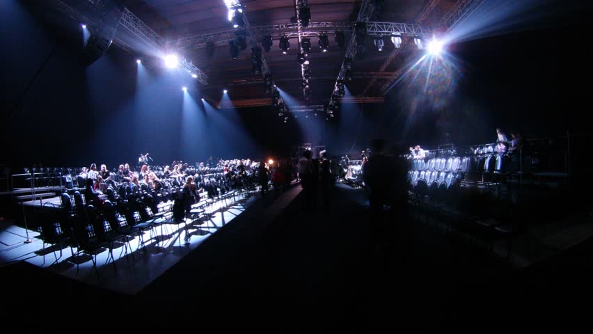 MOSCOW - APR 8: (Timelapse View) Many visitors crowd near podium in dark after mannequin parade on VOLVO - Week of fashion in Moscow in Gostini dvor, on April 8, 2012 in Moscow, Russia