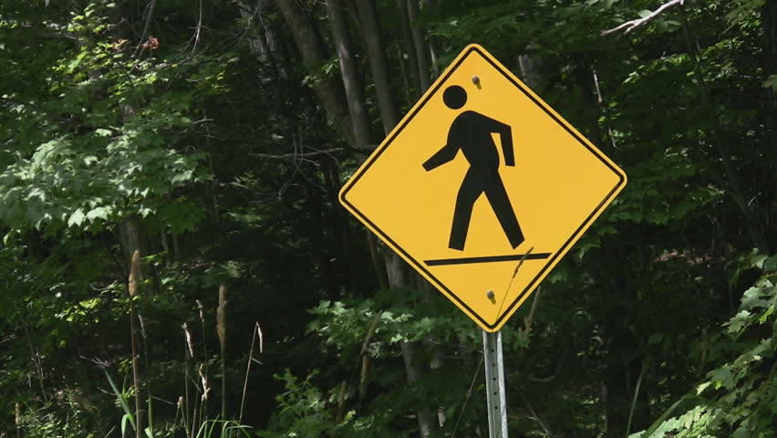 A sign warns to look out for pedestrians on a country road in Ontario, Canada.
