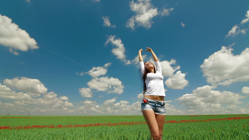Sexy Young Woman Enjoying Summer Day In A Green Wheat Field. Tracking shot