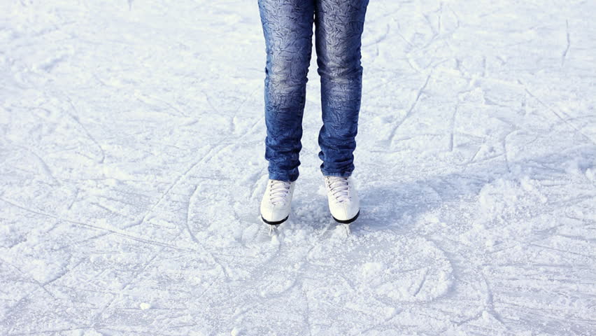 legs teenage girl which making few turns skating on rink in winter