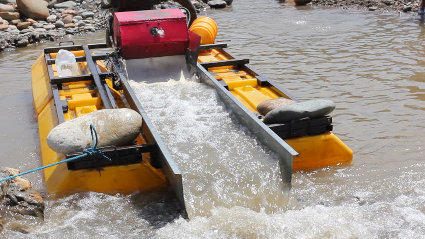 Suction dredge mining placer gold deposits on the Rio Napo in the Ecuadorian Amazon.