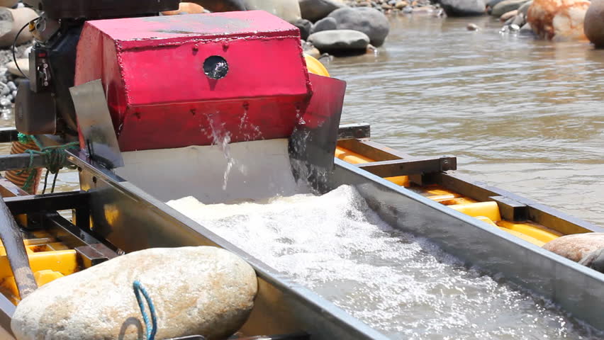 Suction dredge mining placer gold deposits on the Rio Napo in the Ecuadorian Amazon.