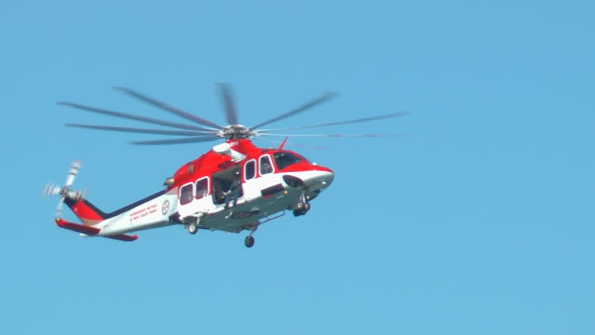 SYDNEY, AUSTRALIA â JUNE 2012: A New South Wales Ambulance Service helicopter flies during a search and rescue mission on June 9, 2012 near La Perouse, Sydney, Australia.