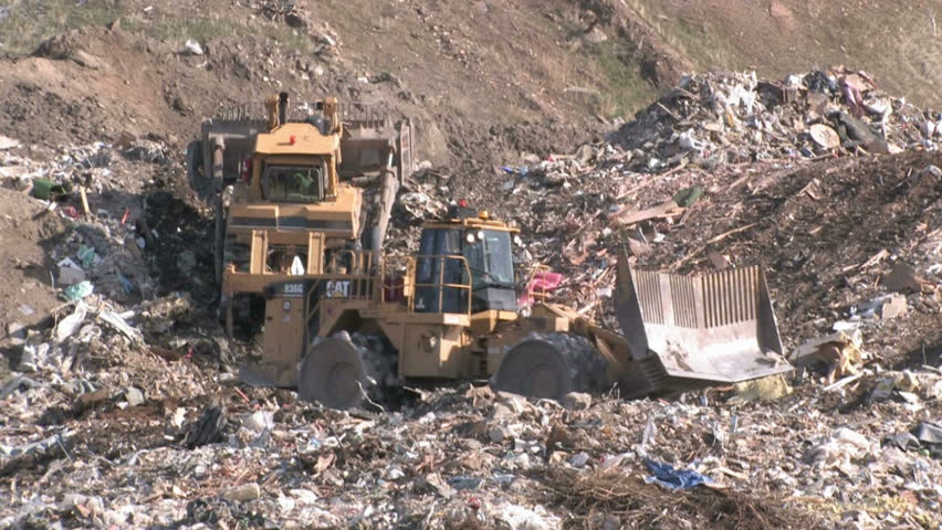 SALT LAKE CITY - CIRCA 2008: Bull dozers moving garbage and trash around in garbage dump circa 2008 in Salt Lake City, Utah.