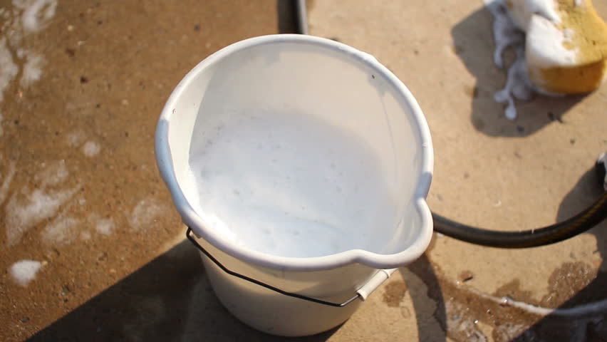 Filling a wash bucket.