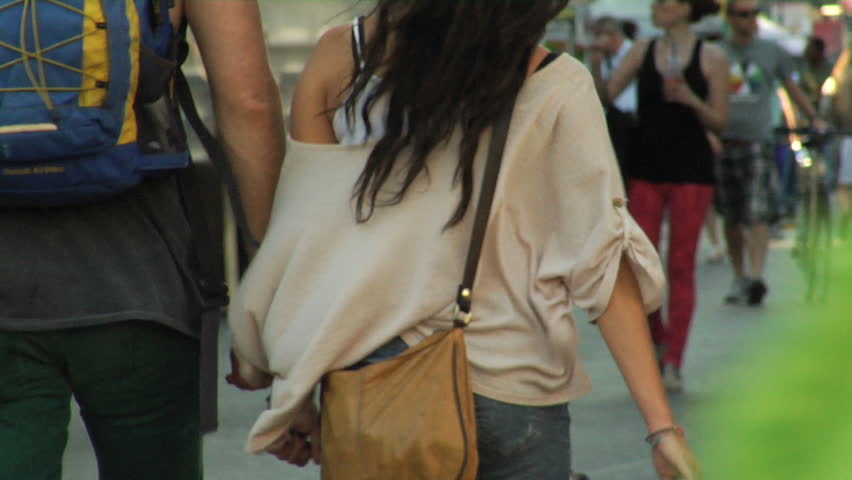 people walk at a street fair in the summer