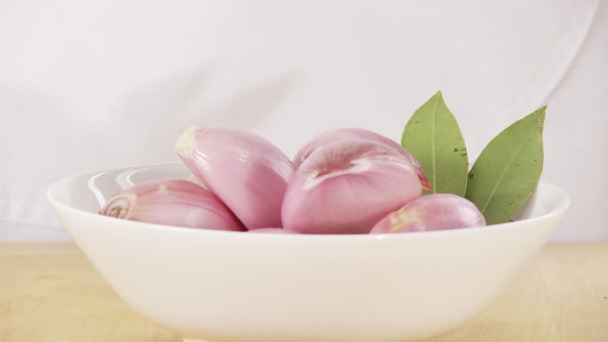 Peeled shallots being quartered