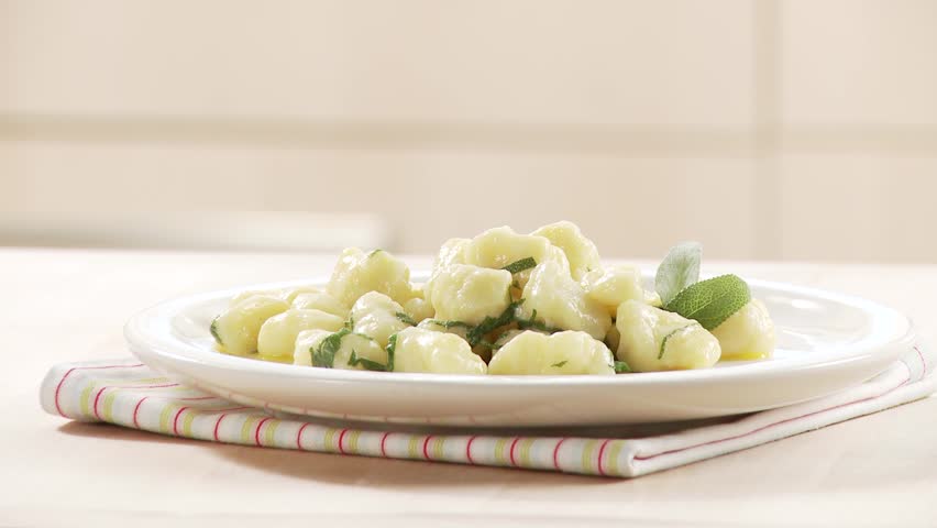 Gnocci with sage butter being arranged