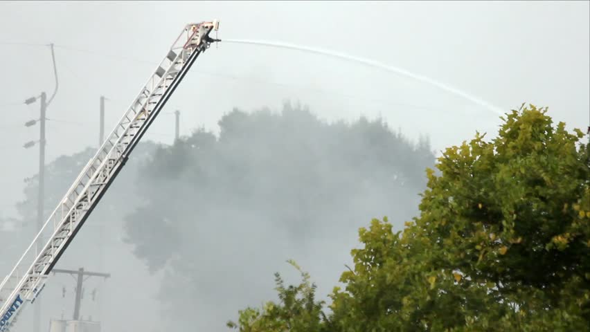 Ladder Mounted Water Cannon In Action At Outdoor Fire