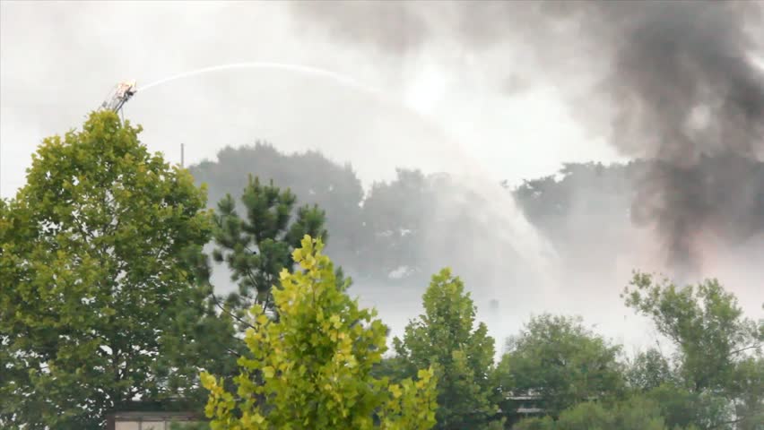 Ladder Mounted Remote Control Water Cannon Spraying Water On Large Outdoor Fire