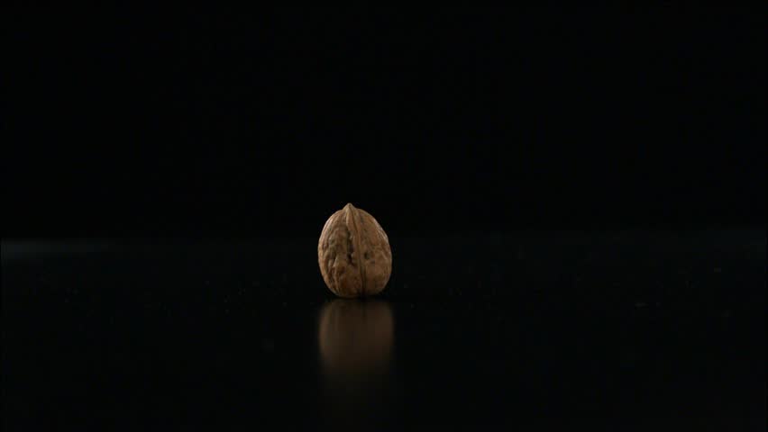 Walnut being smashed by a hammer