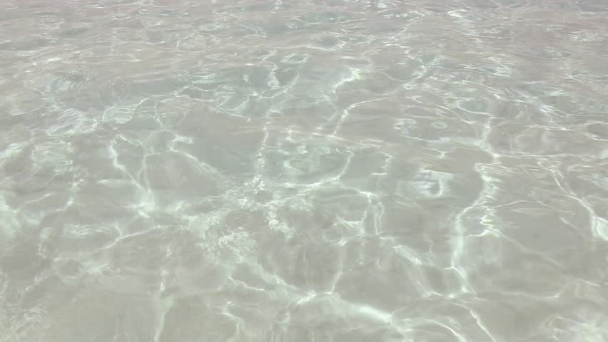 beautiful shore beach with ripple and wavy water reflection in clear bottom white sand