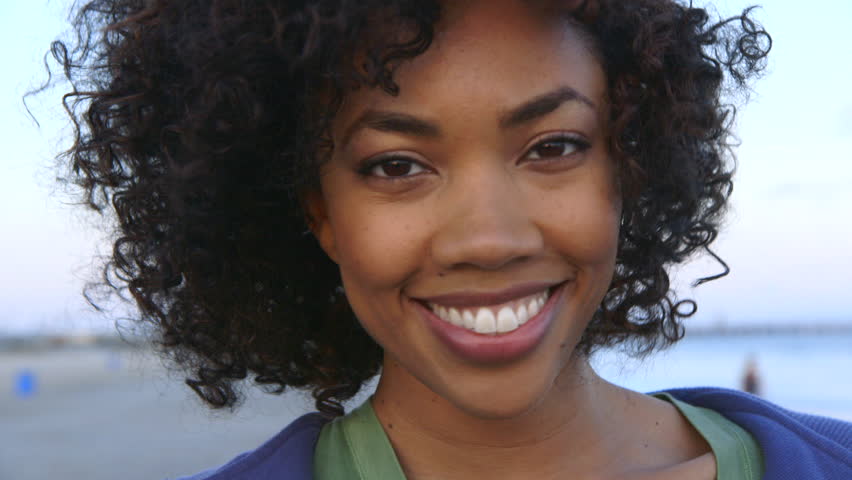 Portrait of woman smiling at beach