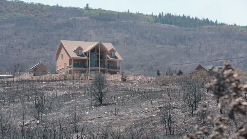 INDIANOLA, SANPETE, UTAH 3 JUL 2012: Luxury home survives destructive wildfire. Charred and burnt homes and business. Wood Hollow central Utah. FEMA Federal Government assistance.