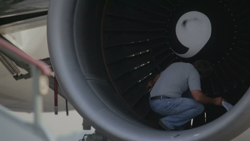 Man checks propeller blades of the turbine engine aircraft