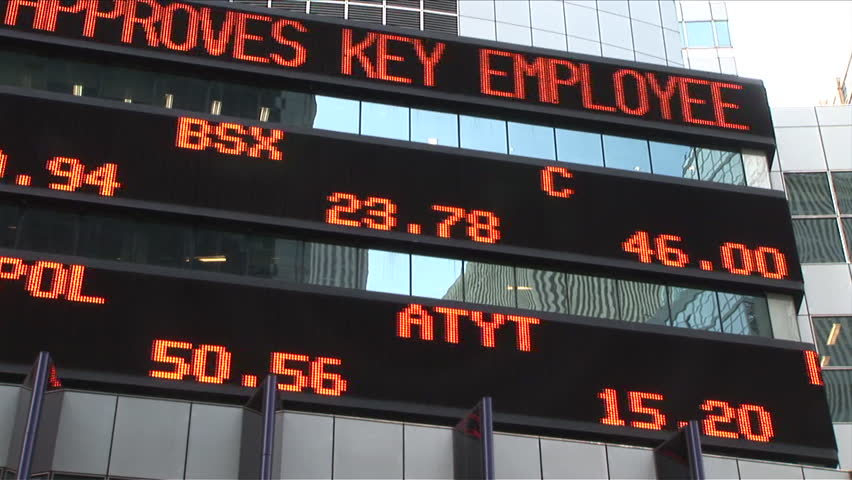 New York, NY - CIRCA March 2006: Pan in the same direction of the as the flow of an electronic stock ticker displays the current prices of select stocks