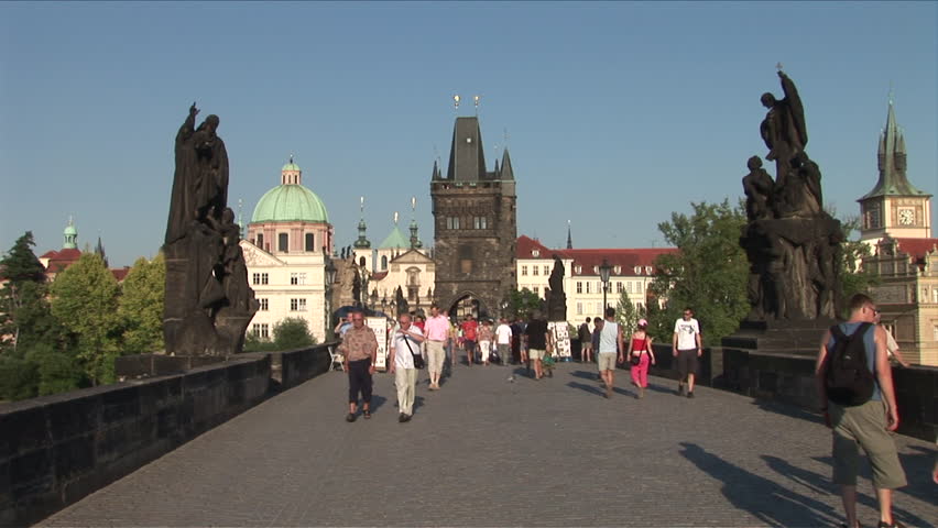 Prague, Czech Rep. - CIRCA July, 2006: Tourists cross the Charles Bridge which spans the Vltava river and was built in 1402