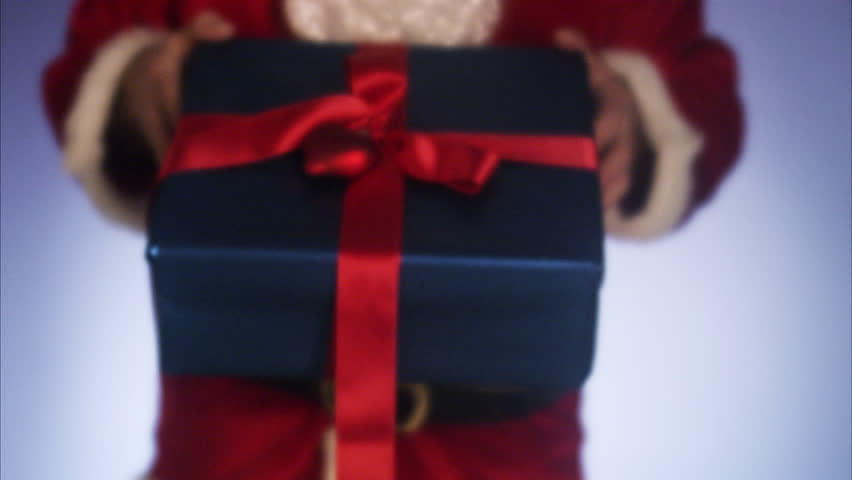 Santa Claus holding out a Christmas gift.