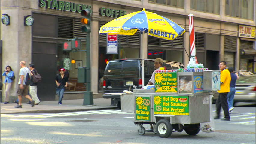 New York, NY - CIRCA 2006: A street vendor drives his cart down the street at the end of his shift