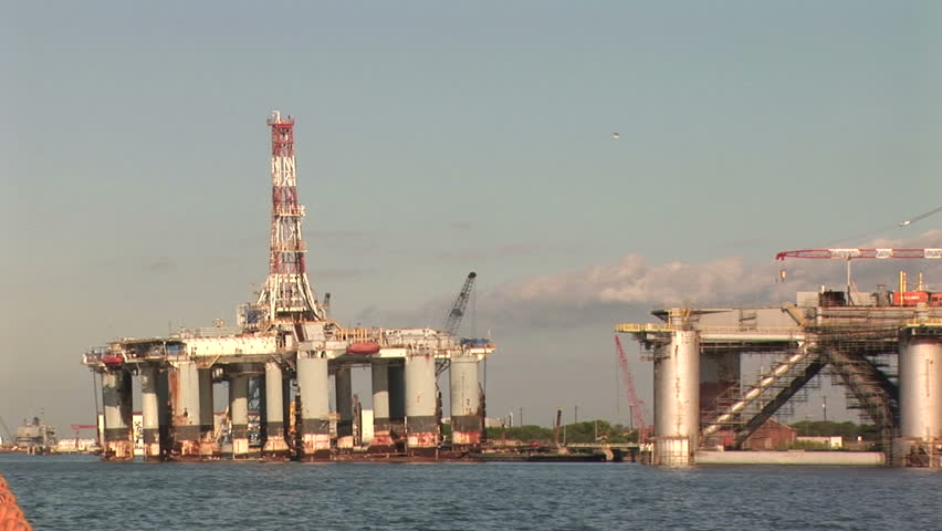 Fixed or stationary footage of offshore oil and gas drilling platforms under construction. 