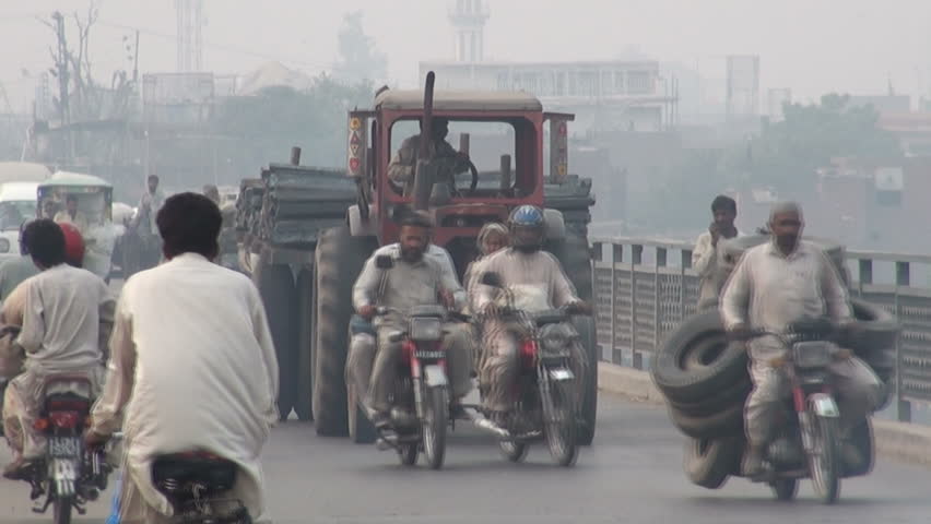 LAHORE - 18 OCTOBER 2010: All kinds of transport cross a bridge on the outskirts of Lahore, Pakistan