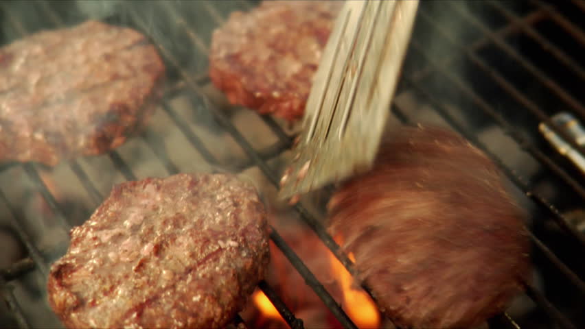 Flipping hamburgers on the grill