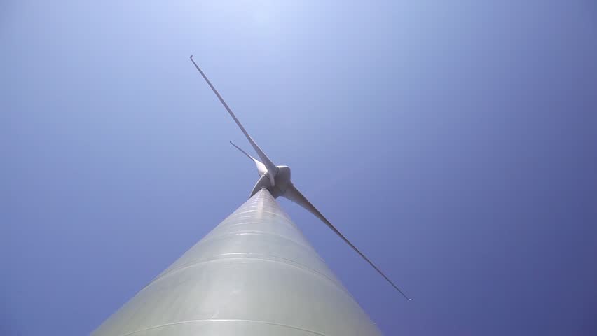 Abstract view of wind turbine with a clear blue sky