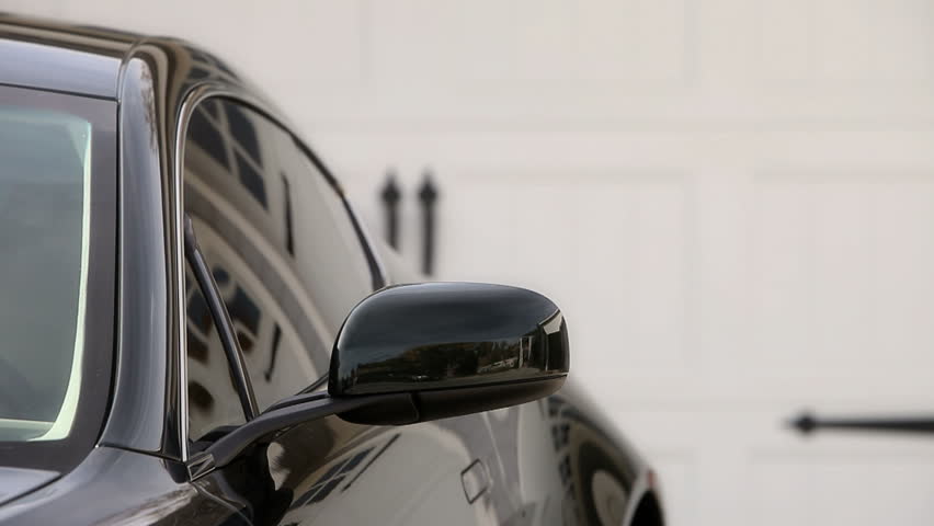 Man getting into Aston Martin on drivers side