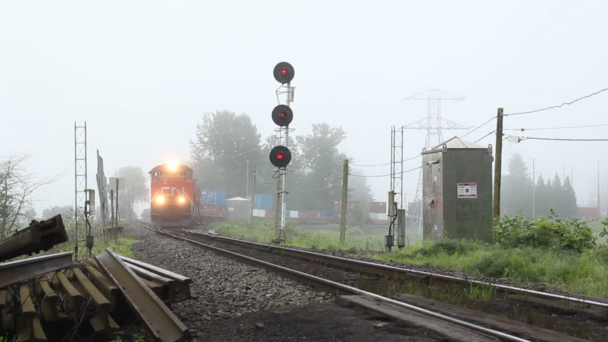 MISSION, BRITISH COLUMBIA - JULY 22: A Canadian National Train emerges out of the fog transporting goods to other parts of the country on July 22, 2012 in Mission, British Columbia, Canada. 