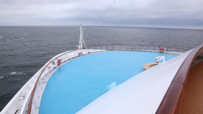Huge liner floats by sea against cloudy sky in afternoon