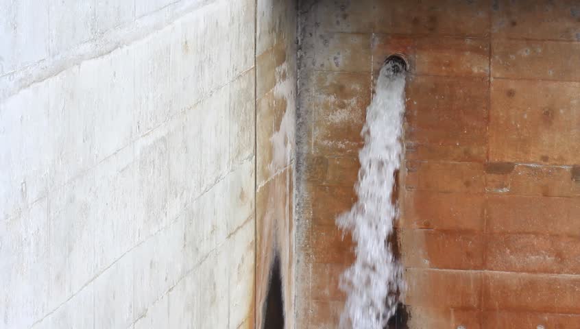water drain from tube on concrete wall