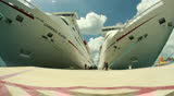COZUMEL, MEXICO - July, 2012 Tourists walk past the cruise ships Carnival Elation and Paradise docked at Cozumel, Mexico. MAY BE SUITABLE FOR EDITORIAL USE ONLY.