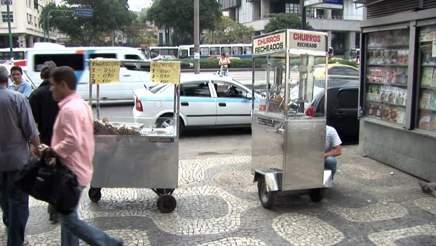 RIO DE JANEIRO, BRAZIL - CIRCA 2010: Busy Street Vendors in Rio De Janeiro, Brazil Rush Hour Traffic in the Background