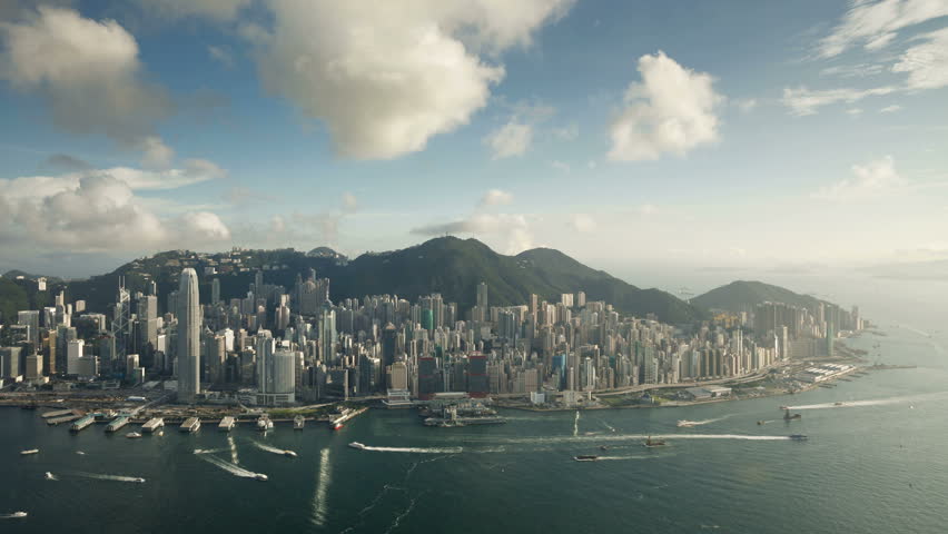 Aerial afternoon view over Hong Kong Island looking towards Victoria Peak showing the busy Victoria Harbour and Financial District of Central, Hong Kong, China 