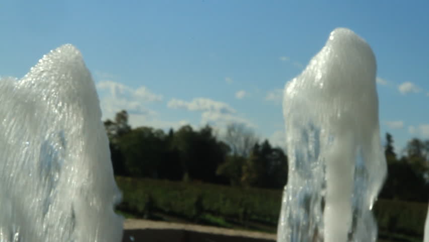 Water shoots out of a fountain in slow motion