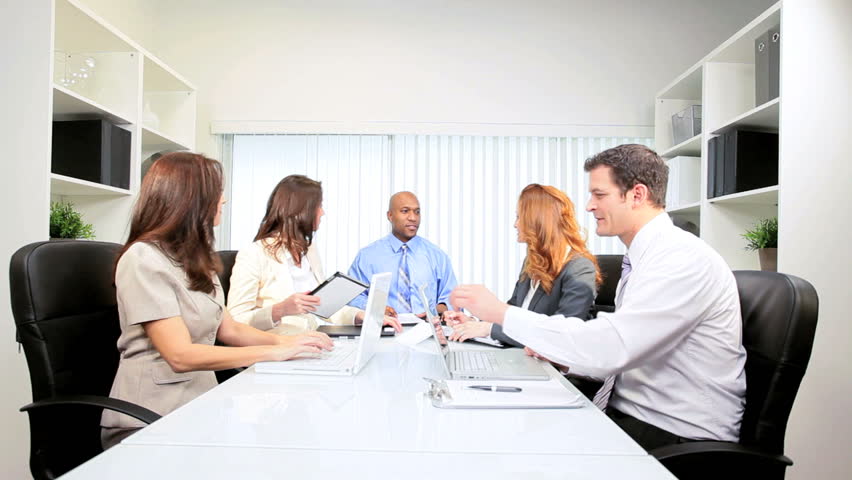 Male African American advertising executive wrapping up successful boardroom team meeting
