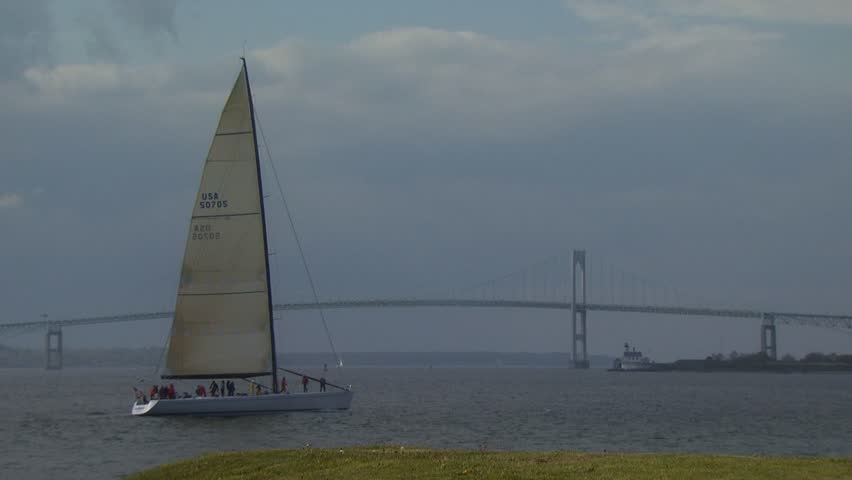 NEWPORT, RHODE ISLAND - CIRCA AUGUST 2007: Large sailboat tacking on Narragansett Bay with span of Newport Bridge in distance