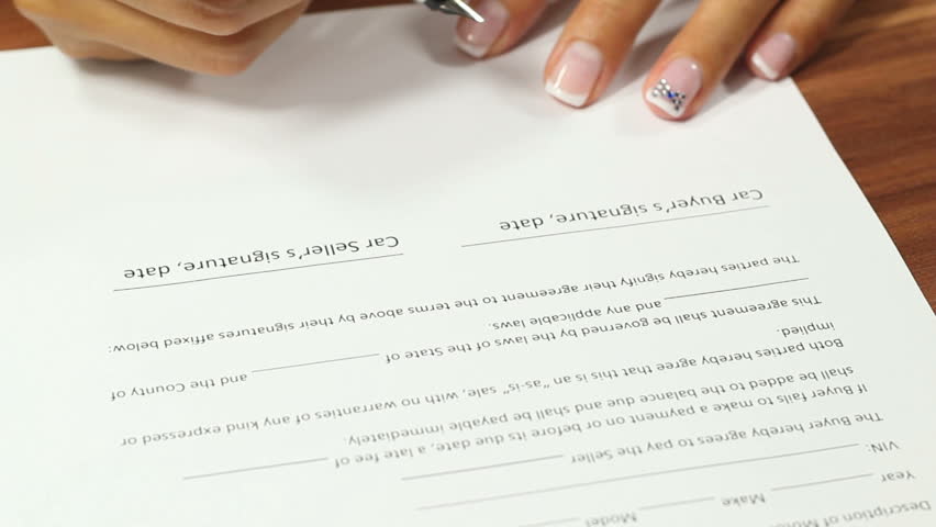 Woman signing on Car Seller signature line of the car sale contract