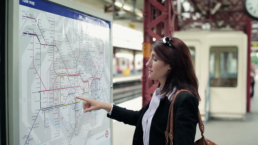 Young businesswoman looking at subway map
