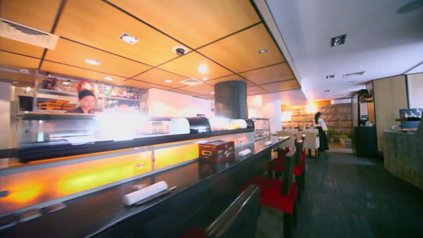 Eastern restaurant with bartenders and waiter, motion through