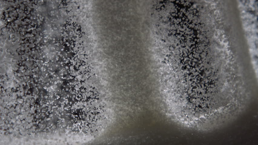 Pouring sugar on black background shooting with high speed camera.