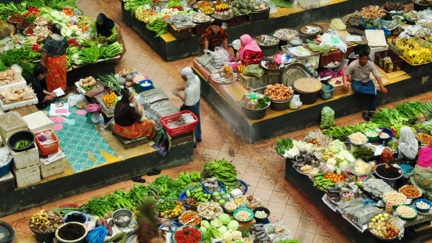 MALAYSIA - JANUARY 24: Time lapse of Muslim woman selling fresh vegetables at the traditional bazaar market Siti Khadijah Kota Bahru on January 24, 2011 in Kelantan, Malaysia. 