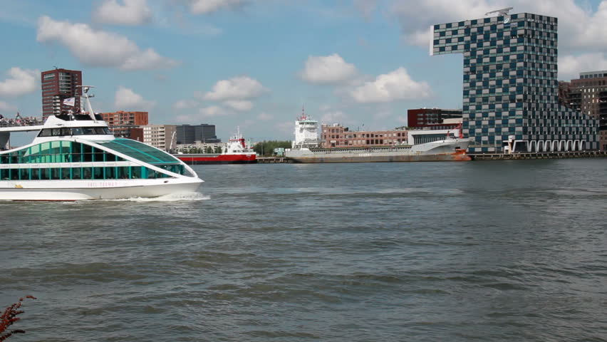 ROTTERDAM - AUGUST 9: Spido tourboat with tourists sails by on the river Meuse in Rotterdam, Holland on August 9, 2012. Rotterdam is Europe's biggest harbor and is visited by many tourists.