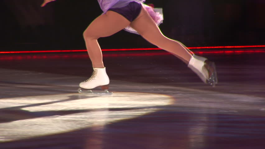 Female Ice Skater spins in Ice Show