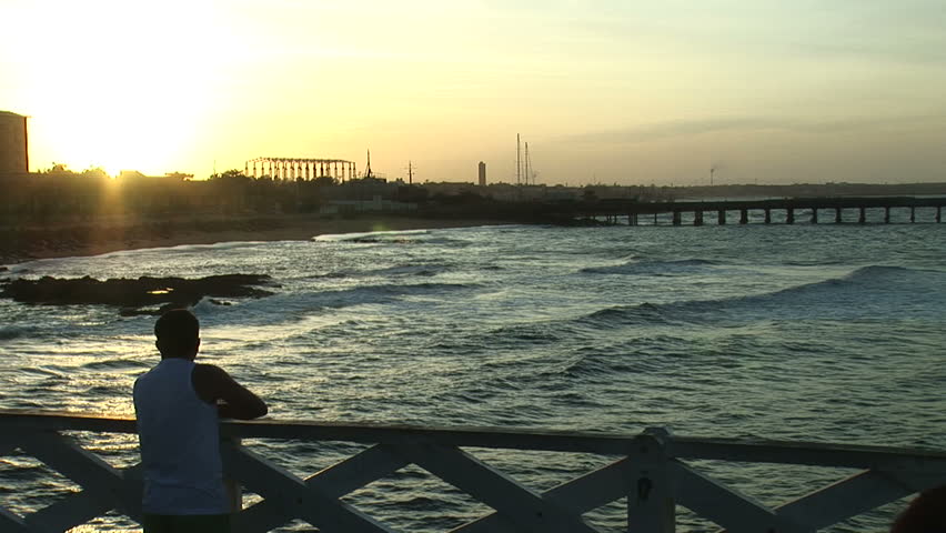 Man watches sunset in Fortaleza, Brazil